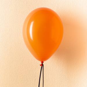 Image of a single floating orange balloon.