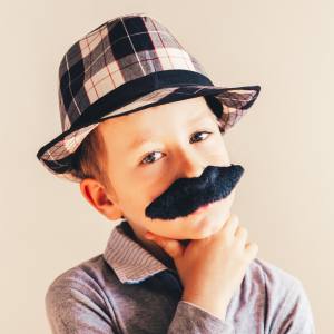 Image of a boy with a fake moustache on